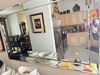 Frameless rectangular mirror on wall showing size