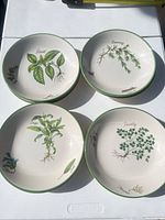 Stacked view of herb-illustrated bowls showing basil, rosemary, sage, parsley patterns