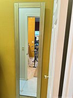 Full view of vertical mirror hanging on wall