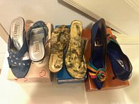 Three pairs of women’s heels displayed on boxes