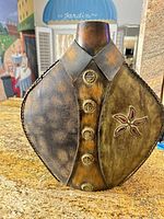 Front view showing embossed buttons, floral inlay, colors and overall shape