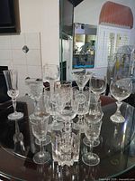 Group shot of 16 mixed crystal and cut glass stemware pieces on table