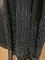 Close-up of bead embellishment on black silk fabric