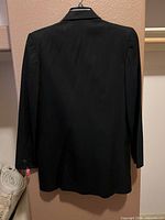 Back view of black jacket on hanger