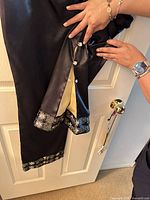 Side view showing gold satin inset panel and decorative buttons