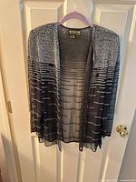 Front view of black sheer beaded jacket on hanger