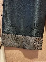 Close-up of gold brocade hem and jacquard fabric