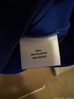 Fabric content tag showing 90% polyester 10% spandex