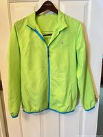 Front view of neon green Champion full-zip jacket on hanger