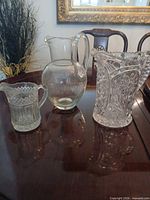All three clear glass pitchers on table
