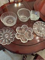 Overview of all clear glass serving pieces on table
