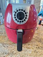 Front view of red Cook's Essentials air fryer showing control panel and handle