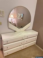 Front view of dresser with round mirror attached