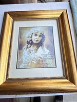 Front view of ornate bronze portrait frame with mat and glass