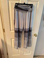 Full view of patterned jersey knit pants hanging on hanger