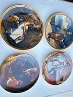 Four Knowles Norman Rockwell plates displayed