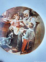 Front view of The Toy Maker plate showing full Rockwell scene