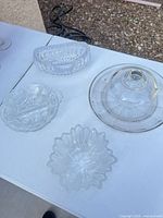 Four clear glass serving pieces on table