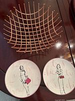 Top view of copper grid bowl with two illustrated plates