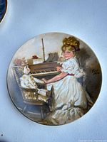 Front view showing artwork of girl at piano