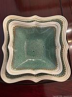 Stacked square plate and dish showing glaze and rim detail