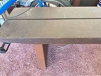 Top view of brown painted wood bench showing two wide slats and surface scratches