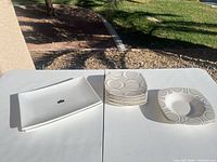 Overall lot: two rectangular platters, stack of salad plates, soup bowl showing pattern