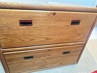 Front view showing two drawers, pull handles, and lock locations