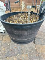 Side view of one planter showing barrel design and soil inside