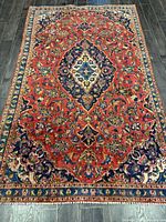 Full view of Persian Kashan rug showing field, medallion and borders