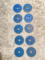 Ten blue Canadian meat ration tokens arranged in two columns