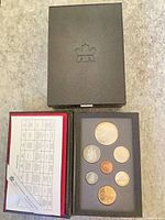 Closed outer box with mint logo and open display case showing coin set and specification card