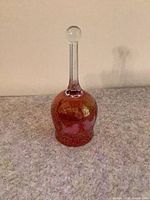 Full upright view of cranberry glass dinner bell