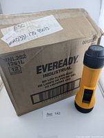 Carton showing Eveready Industrial branding, model and quantity, plus one flashlight displayed upright