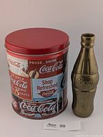 Brass bottle and advertising tin full view