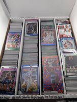 Top view of three-row card storage box filled with NBA Hoops, Prizm, Mosaic cards