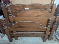 Stacked view showing three of the headboards/footboards with turned posts and scalloped rails