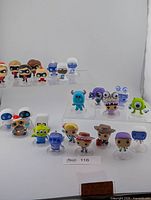 All 20 Pixar Funko mini figurines grouped on risers