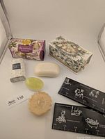 Overall lot showing soaps, candle, scissors and packaging