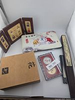 Group shot showing coin case, chess box, stamp display, opera mask case, two folding fans