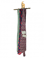 Six patterned ties hanging on brass sunburst hanger