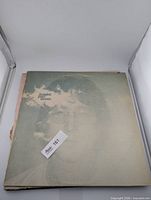 Imagine album cover showing Lennon portrait with clouds