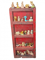 Full view of red wood shelf with all porcelain figures displayed