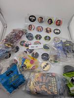 Overview of sealed Batman toys and full POG sheet with gold-foil pieces