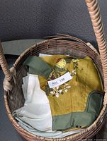 Basket containing apron and folded white napkins