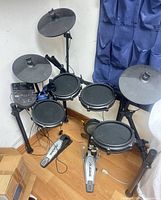 Full view of assembled electronic drum kit with pads, cymbals, module and pedals