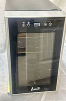 Front view of Avanti wine cooler showing glass door, controls, racks