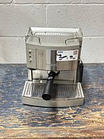 Front view of De'Longhi EC702 espresso machine showing overall condition, portafilter, drip tray and steam wand