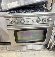 Front view of Jade stainless steel range showing six burners and oven door
