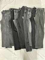 All 11 pairs of women’s size 10 jeans displayed side-by-side front view